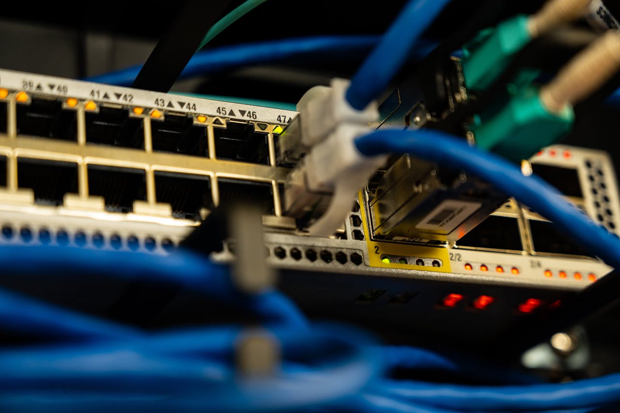 our-story Close-up image of ethernet cables plugged into a network switch, showcasing IT infrastructure.